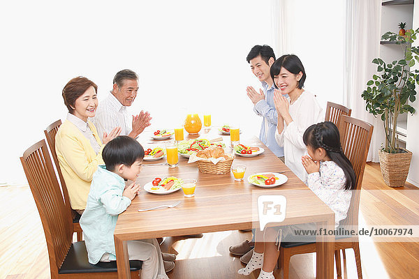 Three-generation Japanese family together in the kitchen