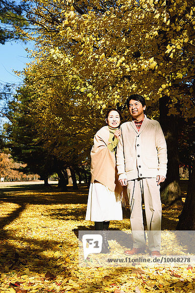 Senior Japanese couple in a city park in Autumn