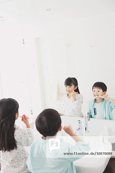 Japanese kid brushing teeth in the bathroom