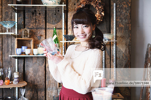 Young Japanese woman enjoying visit to glass workshop in Kawagoe  Japan