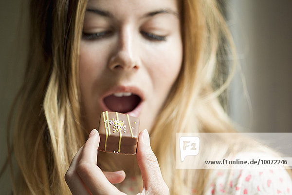 Woman eating a chocolate