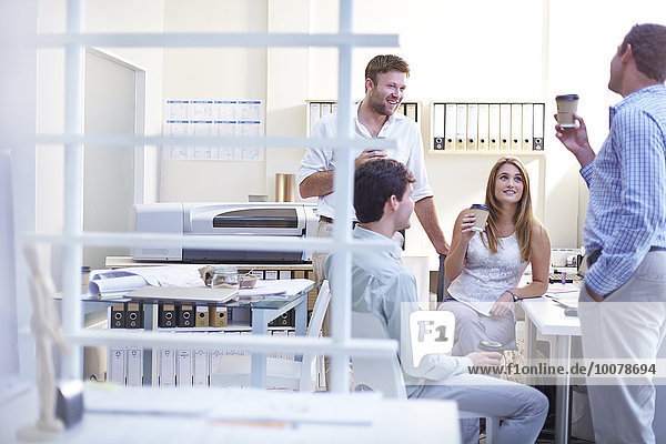 Architects talking and drinking coffee in office