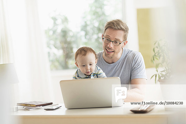 Caucasian father and baby using laptop