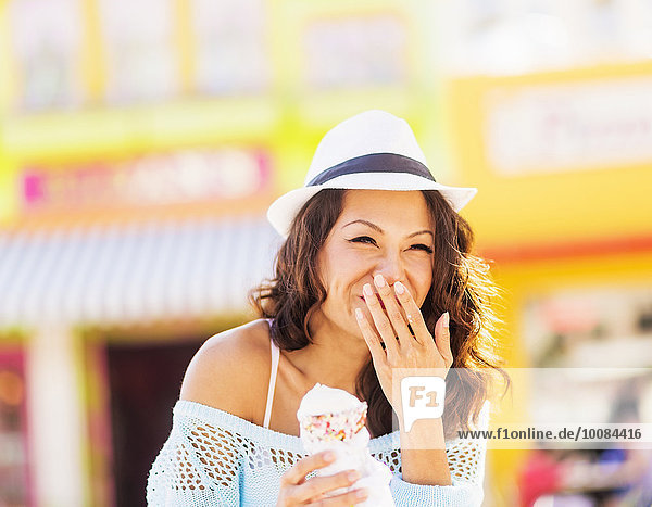Chinese woman eating ice cream cone