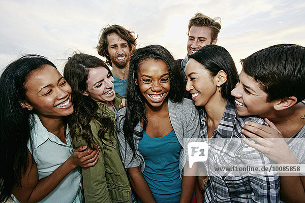 Close up of friends laughing outdoors