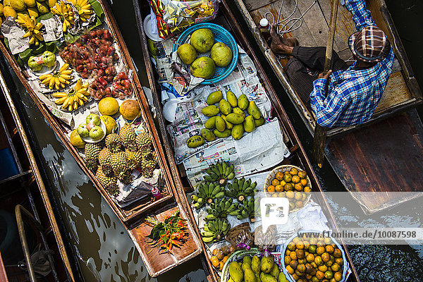 High angle view of merchant selling fruit in canoe