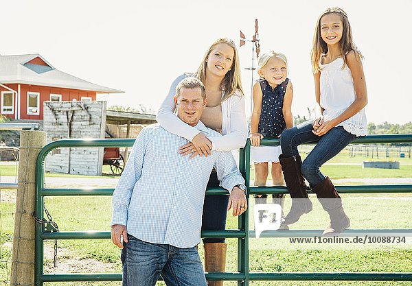 Caucasian family smiling on farm