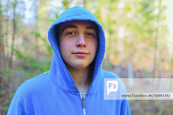 Caucasian teenage boy in forest