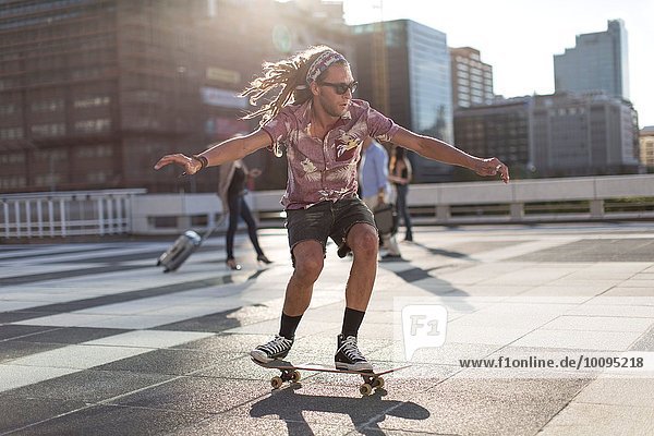 Young man balancing on skateboard