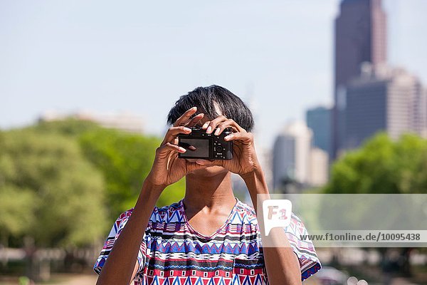 Young man taking selfie in front of city skyline  Philadelphia  Pennsylvania  USA