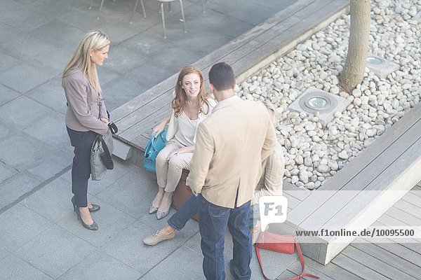 Businessman and women meeting informally on hotel terrace
