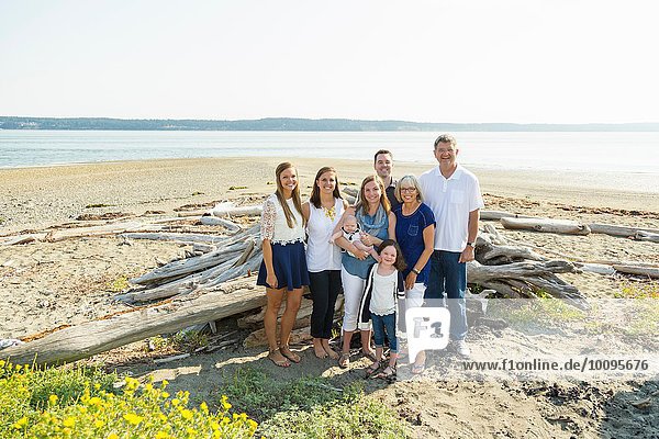 Portrait of three generation family on beach