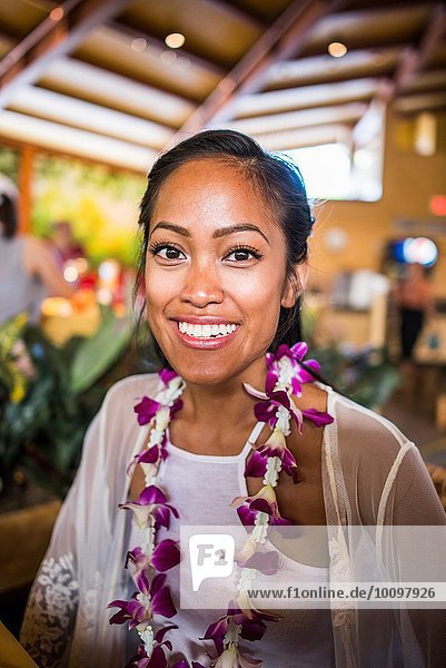 Portrait of young woman wearing flower lei in Polynesian Cultural Centre  Hawaii  USA