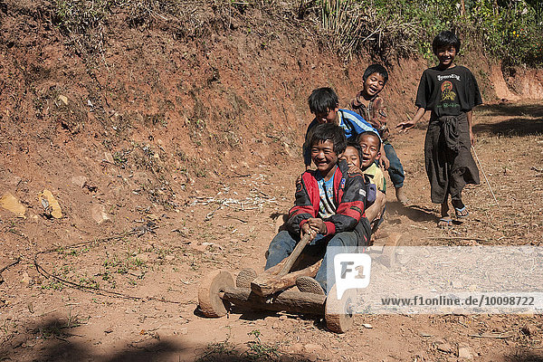 Children from Palaung tribe ride homemade vehicle in Kalaw  Shan State  Myanmar  Asia