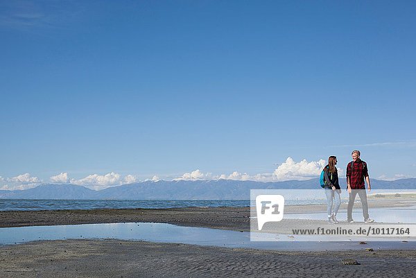 Young couple walking  looking at each other  Great Salt Lake  Utah  USA