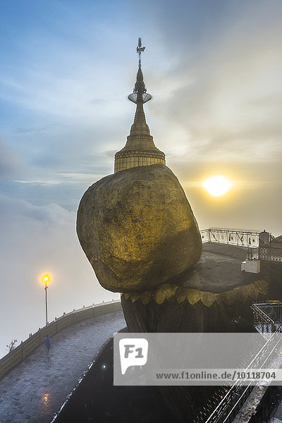 Golden Rock with Kyaiktiyo Pagoda in fog and sunset Kyaikto Thaton District Mon State Myanmar Asia