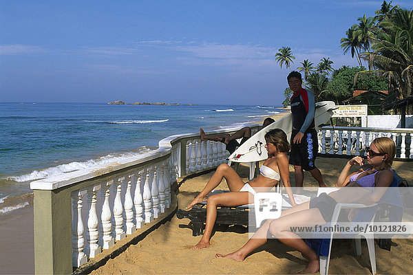 Surfers and sunbathers at Wewala Beach  Sri Lanka  South Asia  Asia