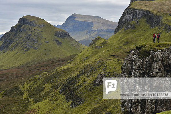 Hikers in volcanic landscape  Leum na Luirginn  Flodigarry  Scottish Highlands  Isle of Skye  Scotland  United Kingdom  Europe
