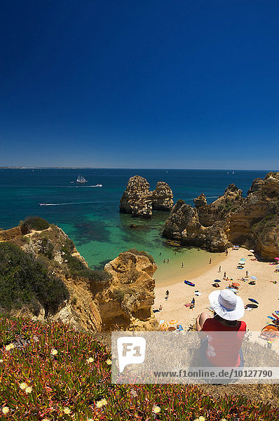 Touristin mit Blick auf die Bucht Praia do Camilo  Algarve  Portugal  Europa
