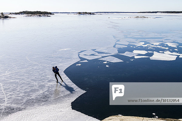 Person ice-skating on frozen water