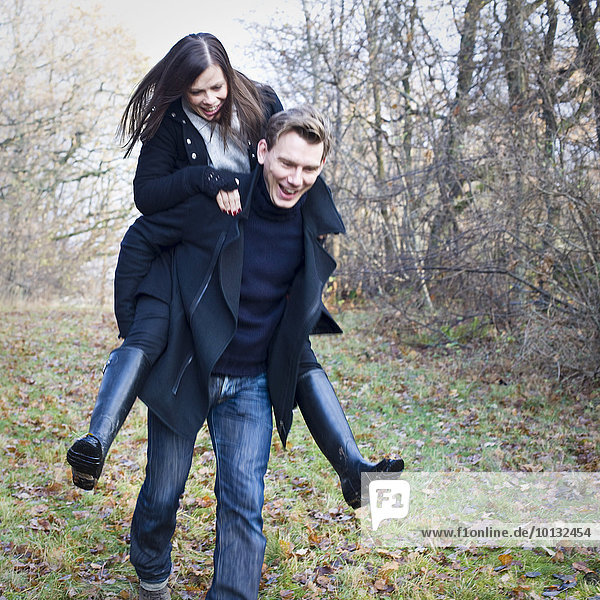 Man give woman piggyback ride