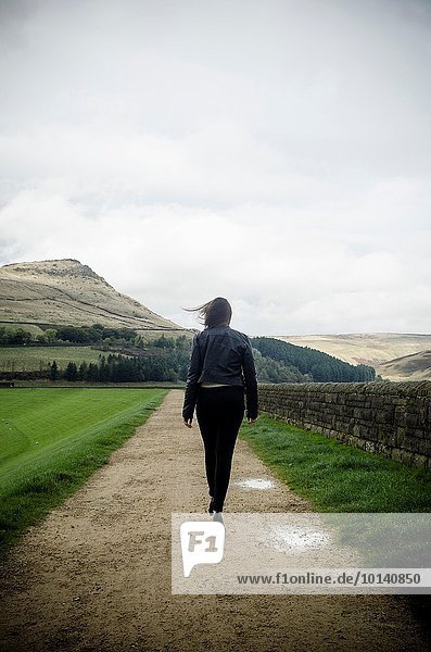 Young woman walking in the countryside.