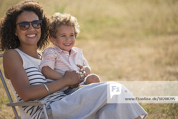 Portrait lächelnde Mutter und Sohn im sonnigen Feld