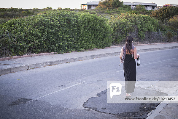 Caucasian woman walking on empty road