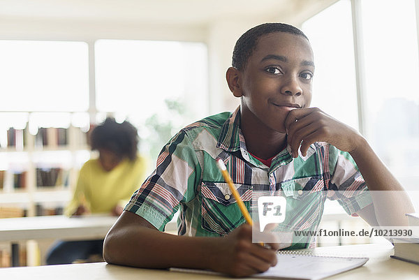 Black student thinking in classroom