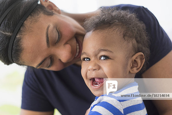 Close up of mixed race mother and baby son laughing
