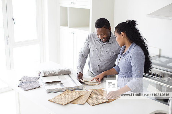 Couple examining fabric swatches in new home
