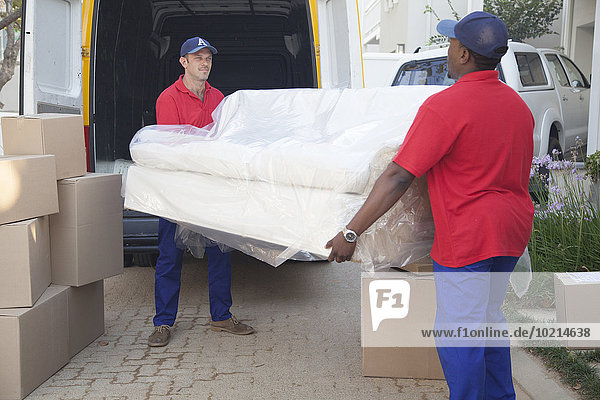 Movers carrying sofa to new home