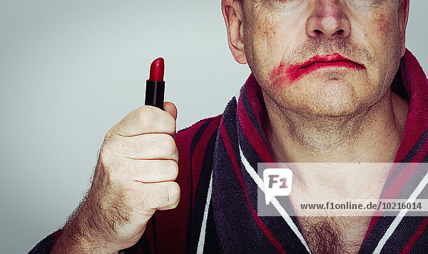 Caucasian man wearing smeared lipstick