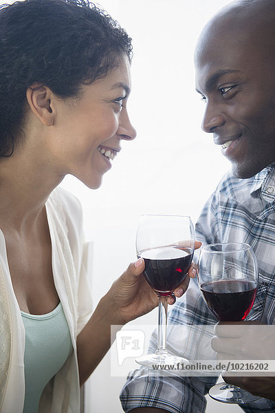 Couple drinking glasses of red wine