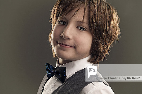 Smiling boy wearing dress shirt and bow tie