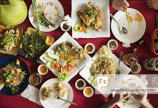 Overhead view of seafood and salad dishes on table