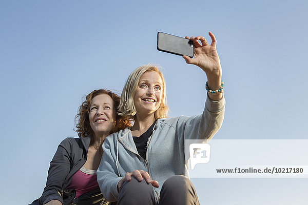 Low angle view of Caucasian women taking selfie