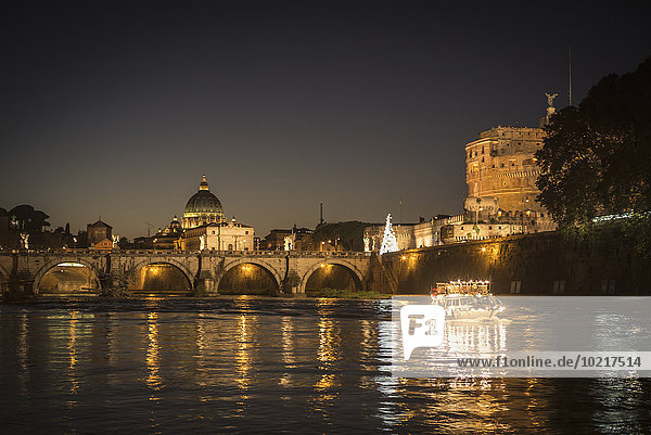 Illuminated bridge over river  Rome  Italy