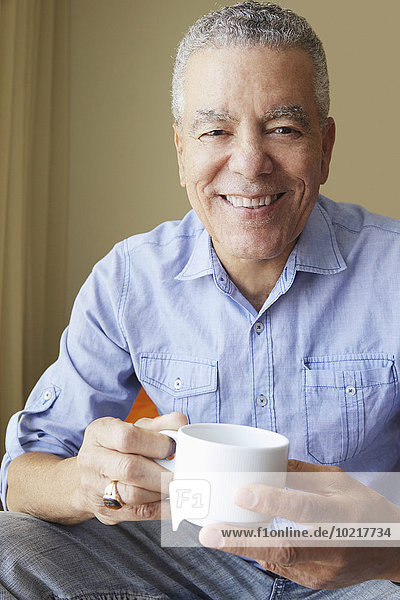 Older Black man drinking coffee