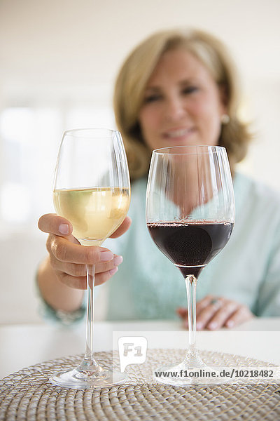 Caucasian woman choosing white wine and red wine