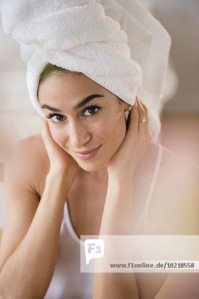 Woman drying her hair with towel
