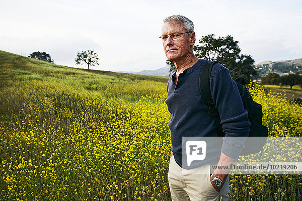 Caucasian man standing in tall grass