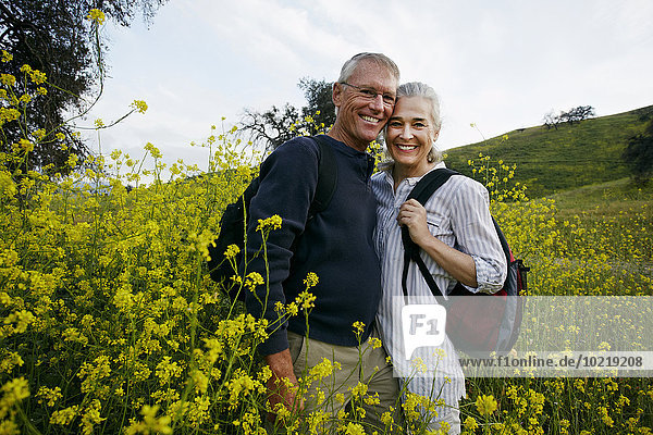 Caucasian couple standing in tall grass
