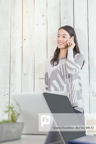 Young Japanese woman working in a stylish office