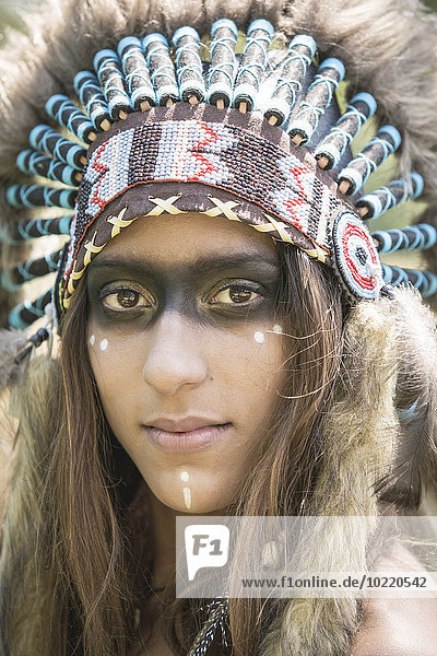 Portrait of young woman masquerade as an Indian