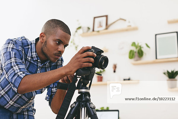 Young man at work in his photographic studio