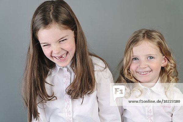 Portrait of two little sisters having fun