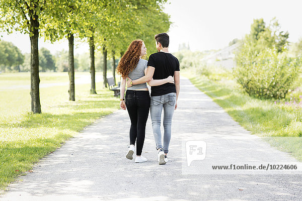 Teenage couple in love walking arm in arm