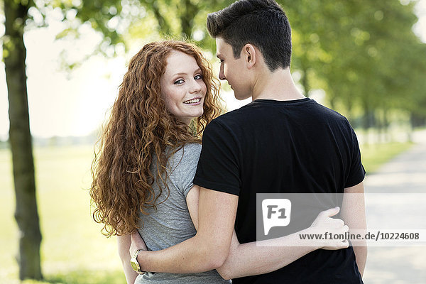 Teenage couple in love arm in arm