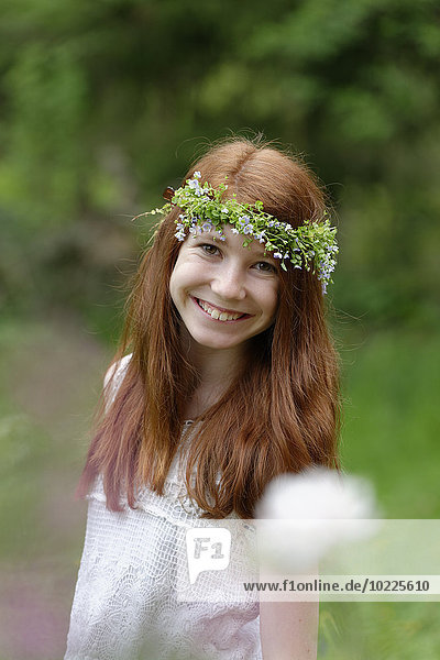 Portrait of smiling girl wearing floral wreath